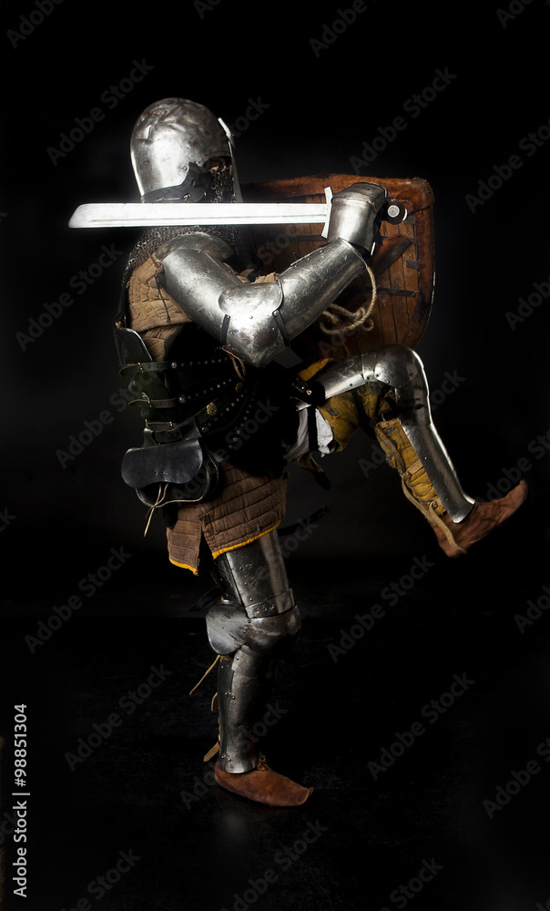 Fototapeta premium Medieval knight in full armor attacks