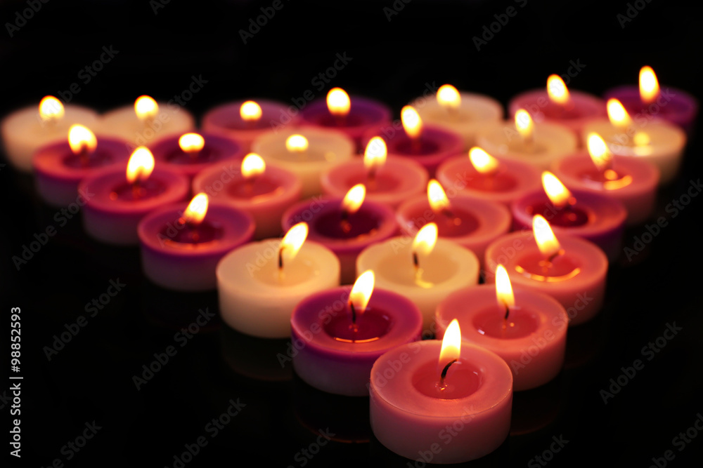 Many burning small candles on dark background Many burning small candles on dark background