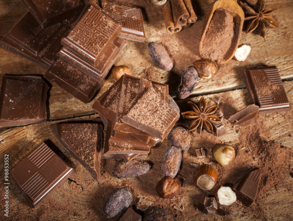 Chocolate pieces on wooden background Chocolate pieces on wooden background