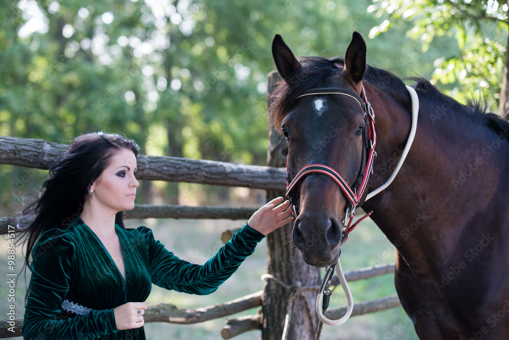 Obraz premium Young beautiful girl with a horse on nature