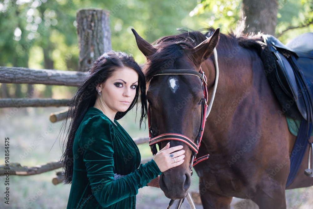 Obraz premium Young beautiful girl with a horse on nature