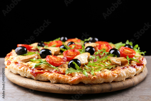 Delicious tasty pizza on black background