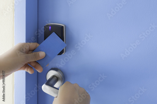 left hand hold key card touch on electronic pad lock access cont
