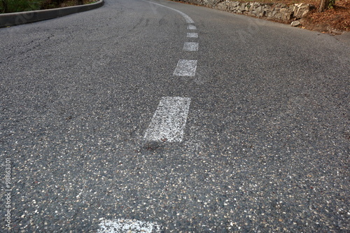 Paved road with dividing line. Focus on foreground