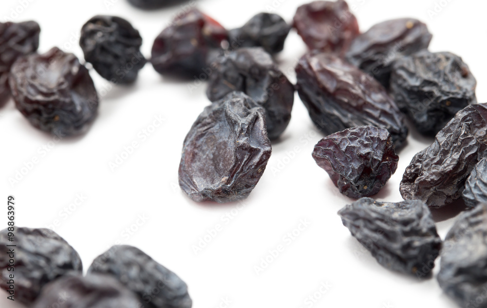 Black raisins on a white background. macro Black raisins on a white background. macro
