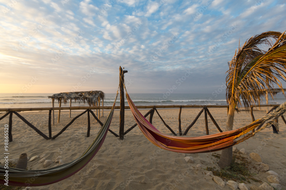 Romantic cozy hammocks with sunset on the beach, Punta Sal, Peru