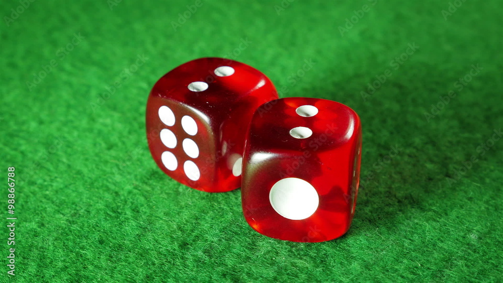 Red dices on the green cloth background. Rotation. Double two. Red dices on the green cloth background. Rotation. Double two.