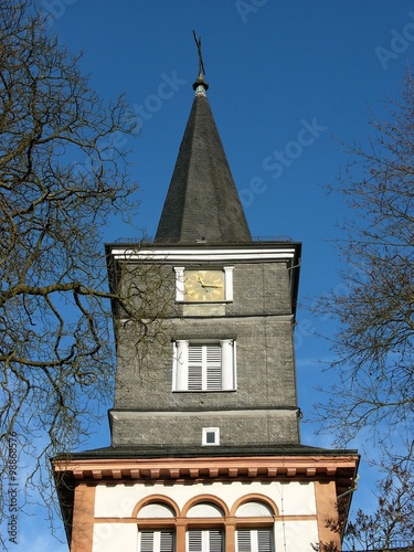 Kirchturm im neoklassizistischen Baustil der evangelischen Kirche in Wißmar bei blauem Himmel und Sonnenschein in der Gemeinde Wettenberg bei Gießen an der Lahn nun Hessen photo