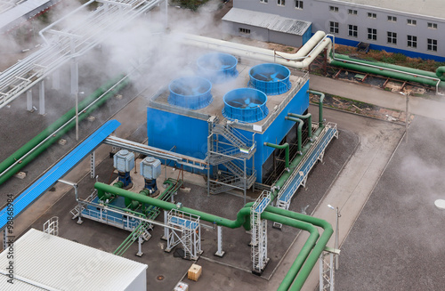 Industrial blue cooling tower at a chemical plant.