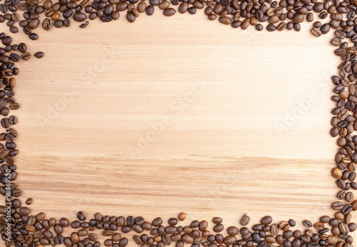 Coffee beans on wooden background, copy space