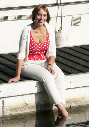 Woman sitting on marina jetty photo