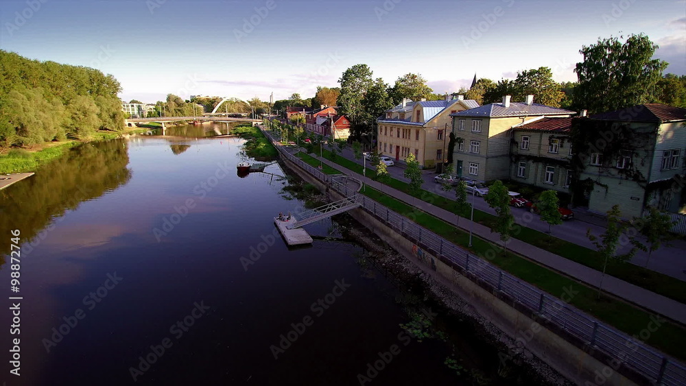 Aerial shot of the Tartus Emajogi river where houses and building are found on the side of the river Aerial shot of the Tartus Emajogi river where houses and building are found on the side of the river
