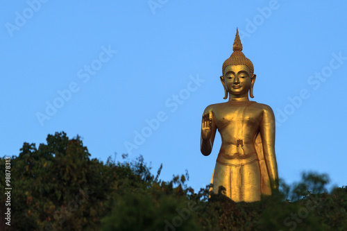 Gold Buddha Statue on blue sky background