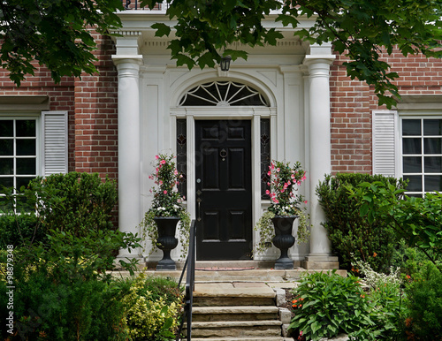 Fototapeta front door with portico entrance and flagstone steps