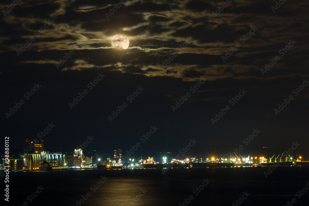 North Vancouver, BC, Canada - December 25, 2015. Full Moon over North Vancouver at night with clouds.
