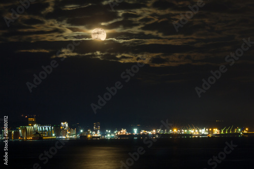 North Vancouver  BC  Canada - December 25  2015. Full Moon over North Vancouver at night with clouds.