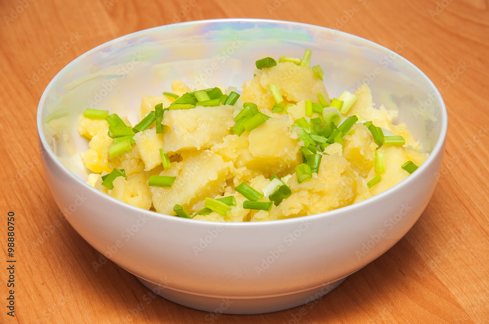 Boiled potatoes with green onion. Natural dish. Hot potatoes in Boiled potatoes with green onion. Natural dish. Hot potatoes in