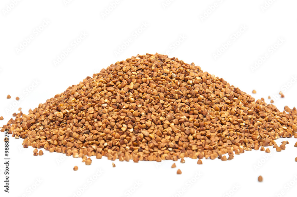 Heap of buckwheat grains on white background, close up view. Heap of buckwheat grains on white background, close up view.