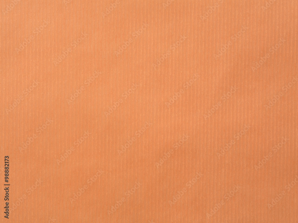 Fototapeta premium The paper with vertical line texture on orange color
