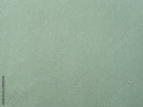 The paper with vertical line texture on green color
