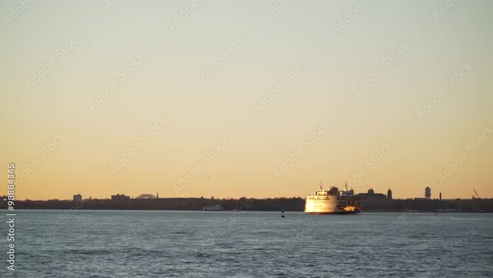 In the soft light of sunset a NYC ferry carries its passengers across the East River. In the soft light of sunset a NYC ferry carries its passengers across the East River.