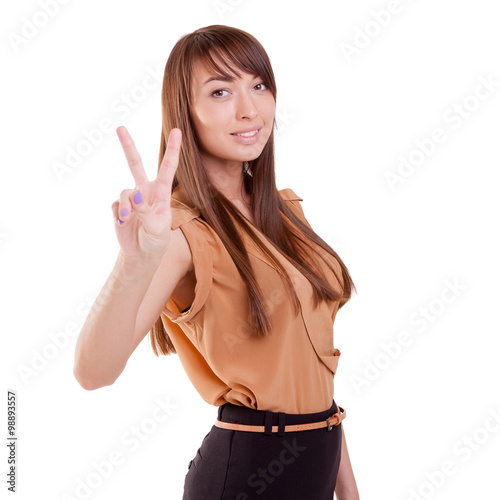Happy teenage gorgeous girl showing victory sign or peace sign. Pointing up 2 fingers. Victory hand sign or gesture. Isolated on white.
