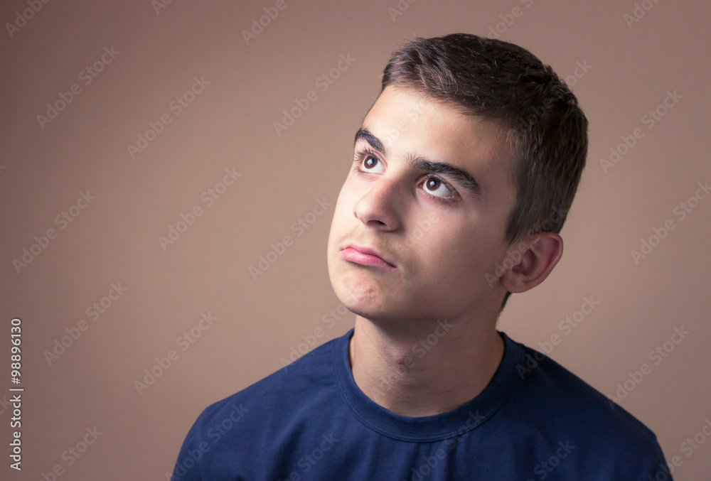 Confused teenager with eyes wide open. Indifferent behavior Confused teenager with eyes wide open. Indifferent behavior