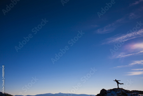 The silhouette of a man in the mountains.