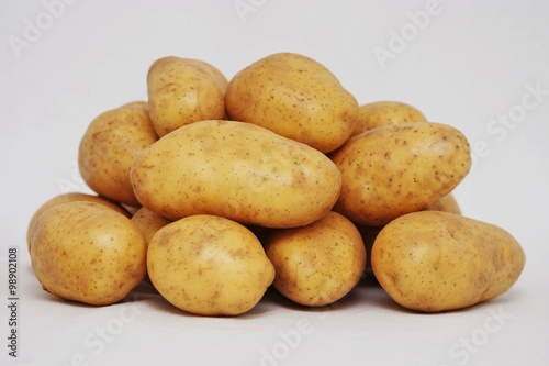 Fresh organic potatoes on white background