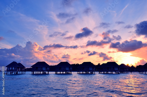 Sunrise over water bungalows in Maldives