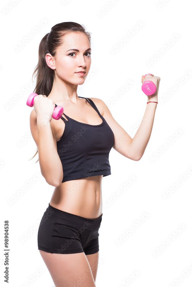 Attractive fit woman exercising in studio with copyspace. Image of healthy young female athlete doing fitness workout against grey background. Attractive fit woman exercising in studio with copyspace. Image of healthy young female athlete doing fitness workout against grey background.