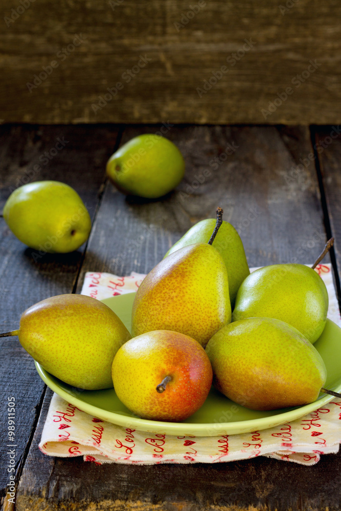 Fresh juicy pears on a table in a rustic style Fresh juicy pears on a table in a rustic style