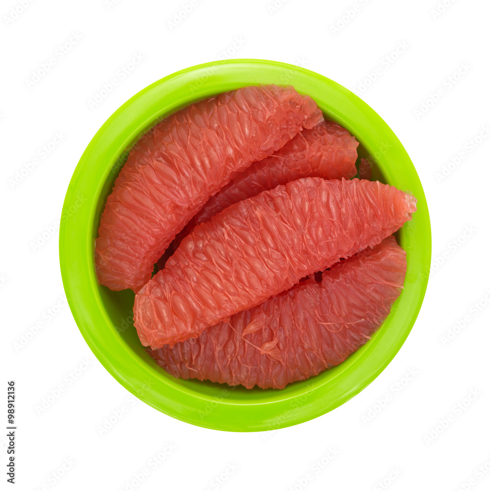 Red grapefruit sections in a green bowl top view Red grapefruit sections in a green bowl top view