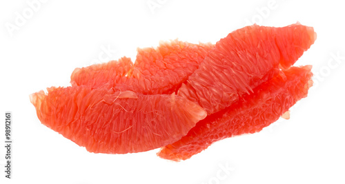 Red grapefruit sections on a white background