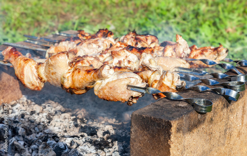 Appetizing hot shish kebab on metal skewers