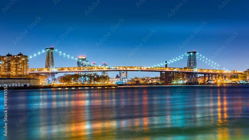 Williamsburg bridge by night, spanning East River between Brooklyn and Manhattan