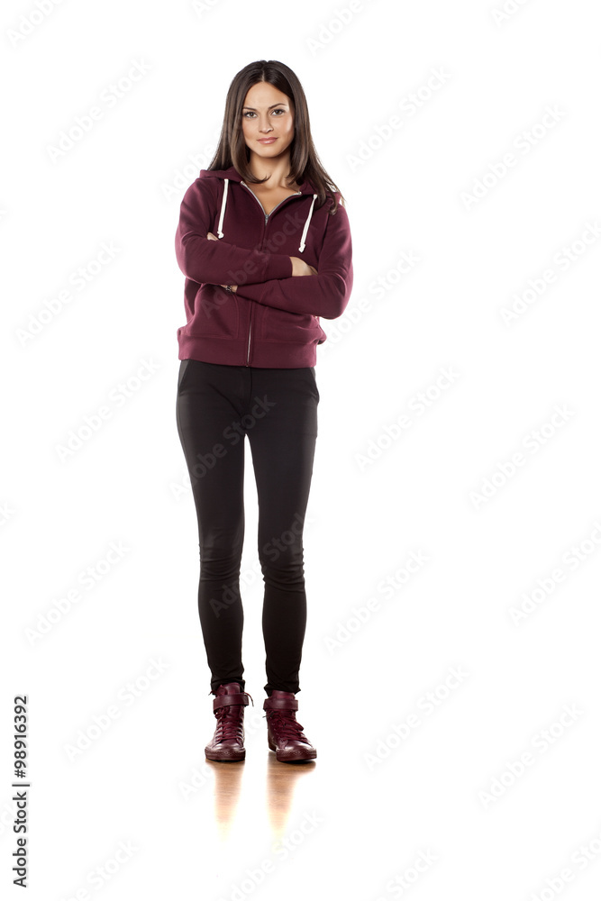 young woman in a track suit pants posing on white background young woman in a track suit pants posing on white background