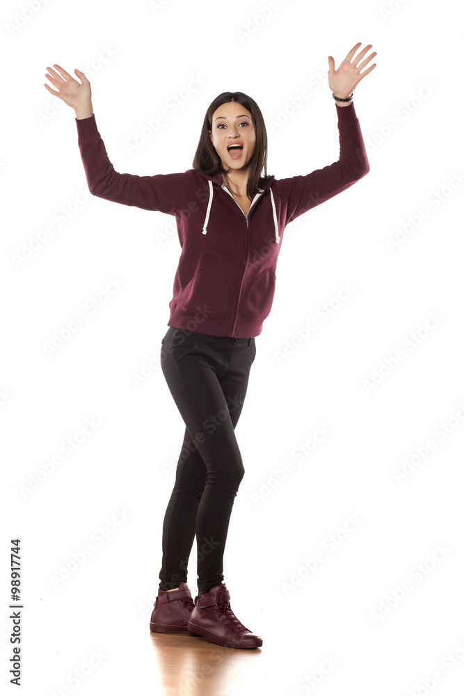 happy young woman in a tracksuit waving hands happy young woman in a tracksuit waving hands