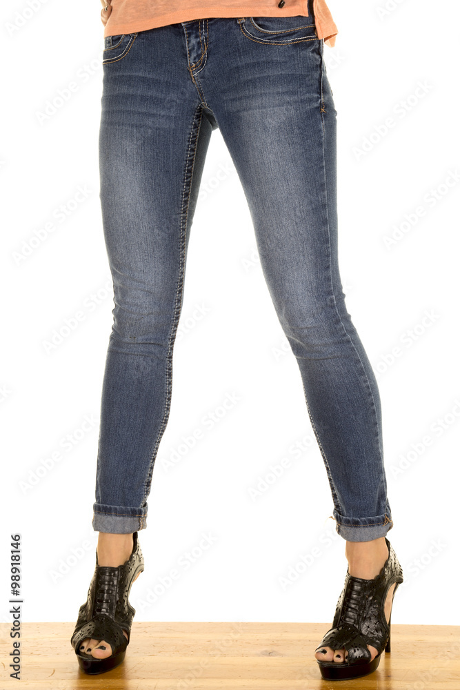 woman legs in denim with black heels stand front woman legs in denim with black heels stand front