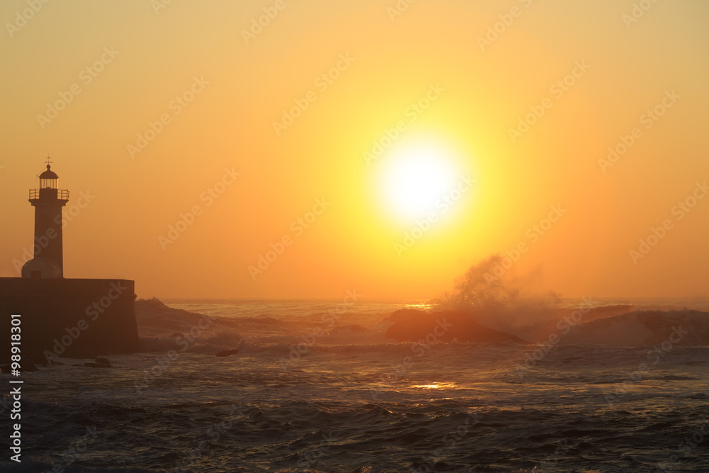 Lighthouse Felgueirasin Porto with wave splash at sunset