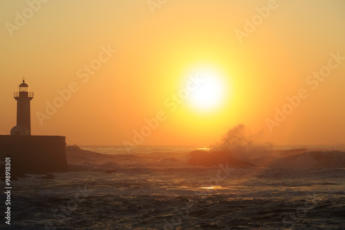 Lighthouse Felgueirasin Porto with wave splash at sunset