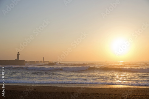 Lighthouse Felgueirasin Porto with waves at sunset