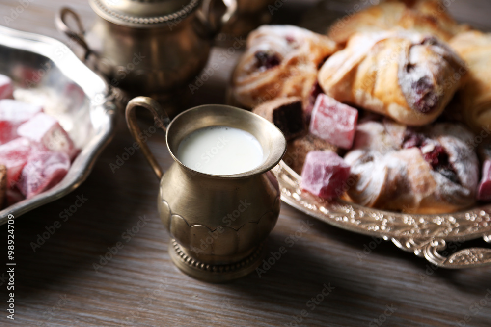 Antique tea-set with Turkish delight and baking on table close-up Antique tea-set with Turkish delight and baking on table close-up