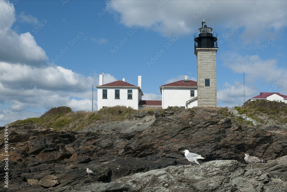 Beavertail Lighthouse Over Rocky Shore in Rhode Island 
