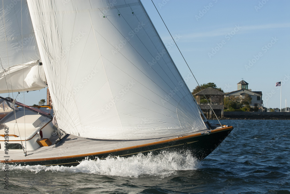 Adventure sailing as sailboat cuts through the water in Newport Harbor, Rhode Island. Newport is known as the yachting capital of the world. Adventure sailing as sailboat cuts through the water in Newport Harbor, Rhode Island. Newport is known as the yachting capital of the world.