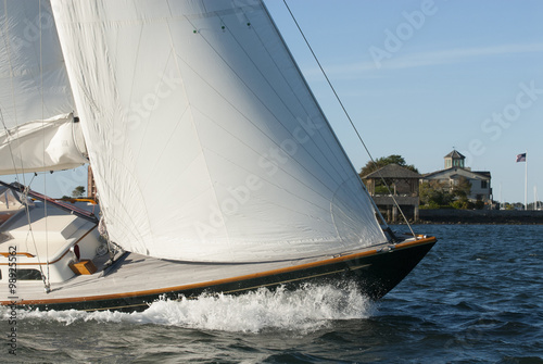 Adventure sailing as sailboat cuts through the water in Newport Harbor, Rhode Island. Newport is known as the yachting capital of the world.