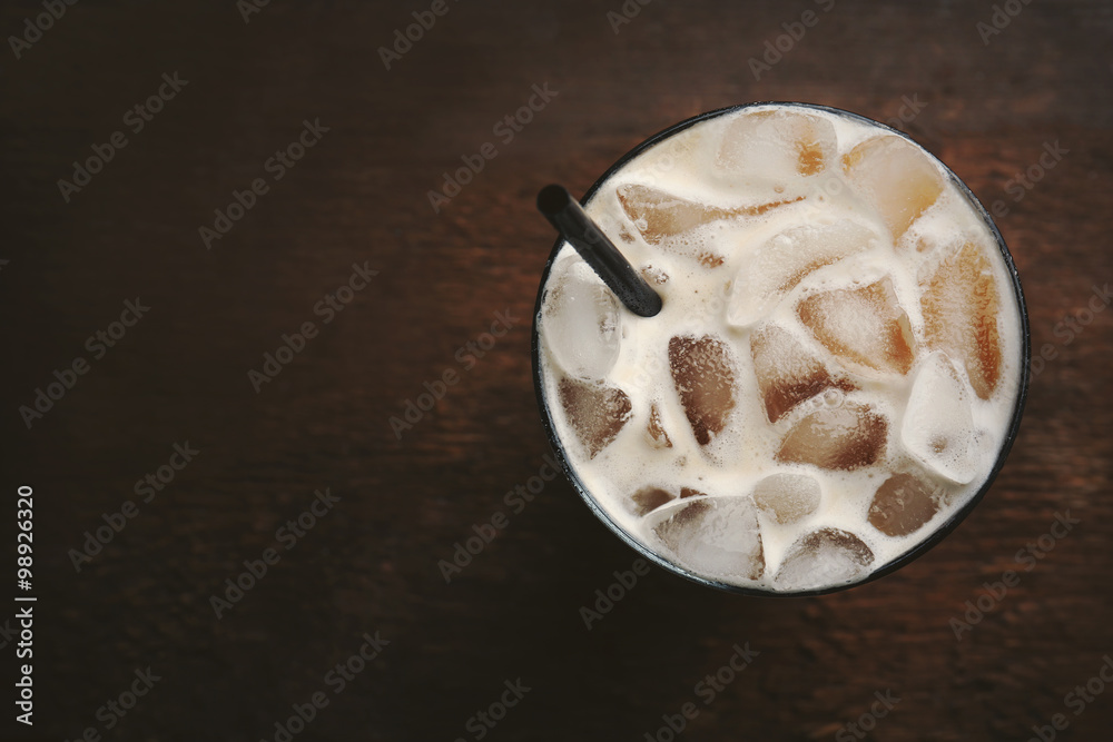 Cup of ice coffee with straw on wooden background Cup of ice coffee with straw on wooden background