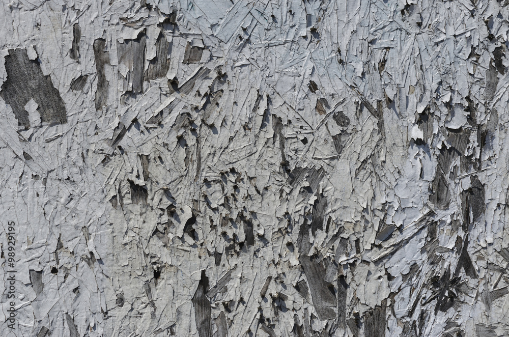 Textured painted wood with cracked and peeling paint