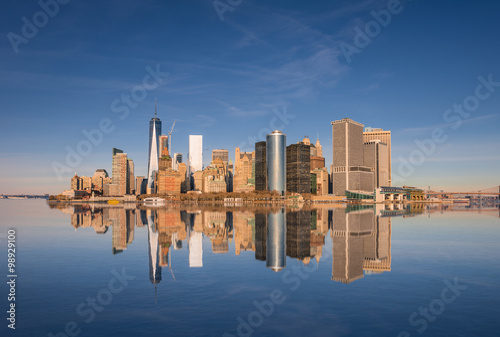 Lower Manhattan skyline panorama over East River with reflection