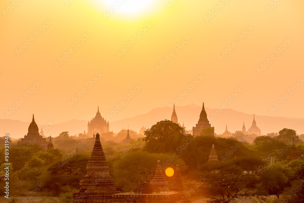 Sunset over pagoda temples with fog of Bagan in Myanmar.